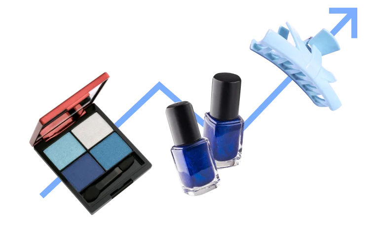 A blue eye shadow compact, two blue nail polish bottles and a blue hair clip appear on a light blue arrow, pointing upwards.
