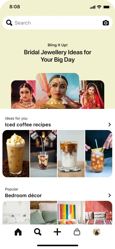 Image of a mobile app search tab with a top-aligned search bar showing three stacked nail Idea Pins titled ‘Pearlescent nails: Shimmer like glitter on the soft side of glam’. Below, a section titled ‘Ideas for you: Iced Coffee Recipes’ with four pins and another section titled ‘Popular: Bedroom décor’, also with four pins.