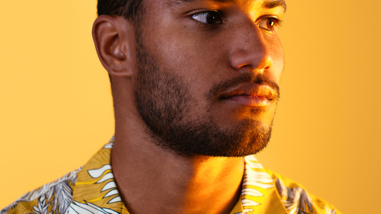 A man wearing a yellow shirt