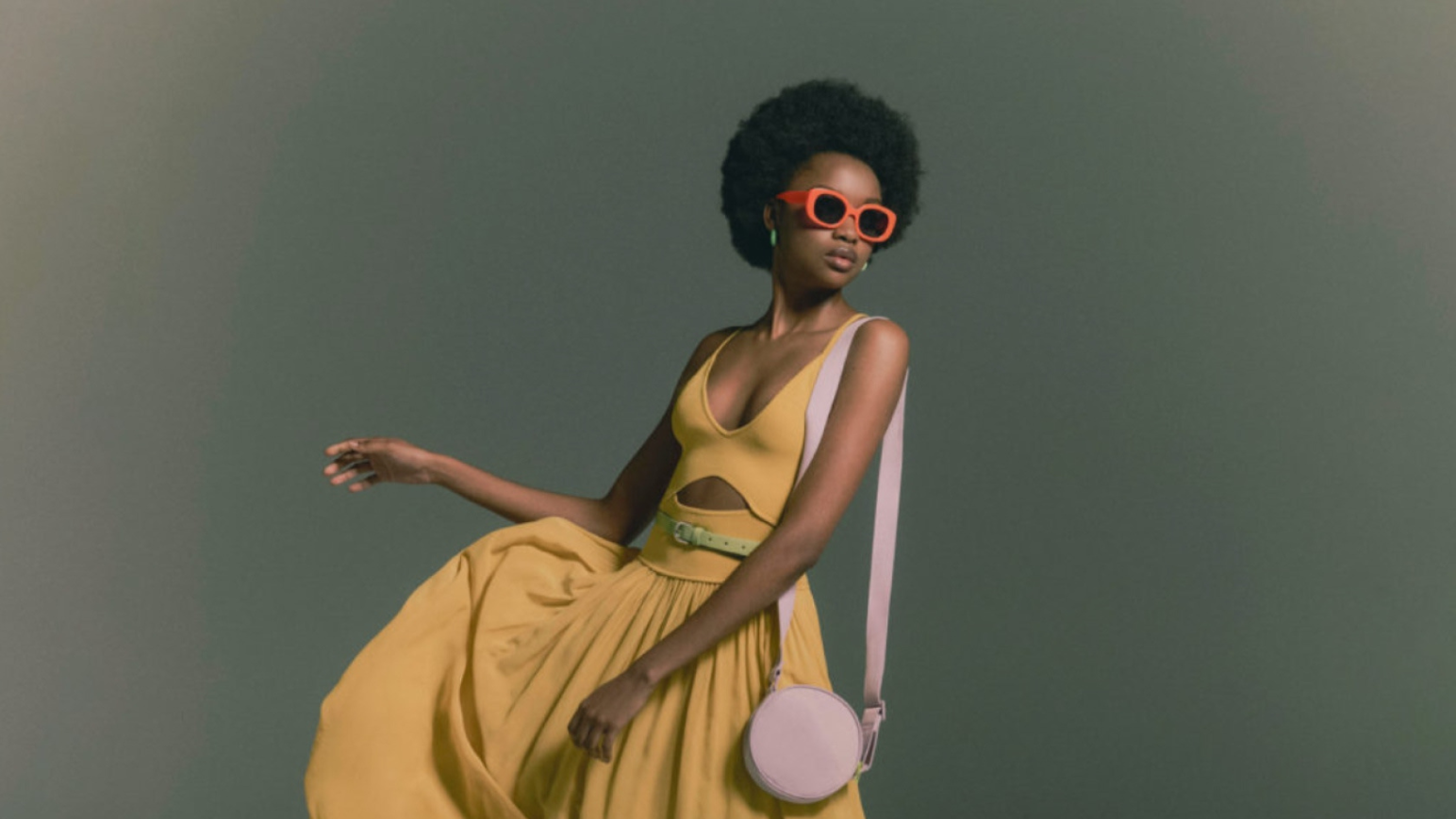 Woman in yellow dress and red sunglasses