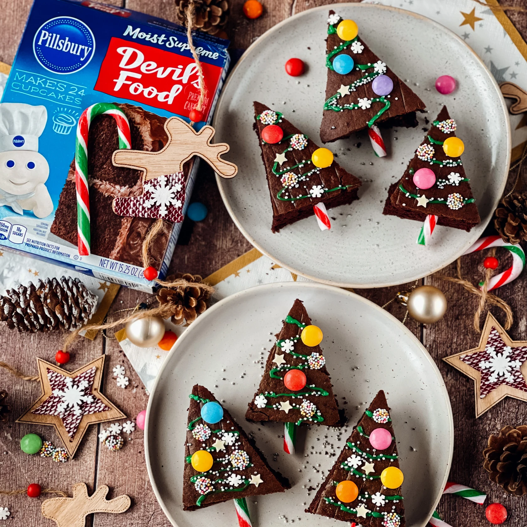 Split image with left side text “Pillsbury Baking boosts awareness and action with holiday video ads” on blue background and right side featuring a box of Devil’s Food cake mix posed next to 6 plated holiday tree-shaped treats. 