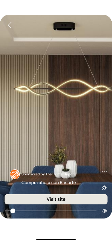 Modern dining room with a sleek, wave-shaped pendant light hanging from the ceiling. Blue upholstered chairs surround a wooden table, creating a warm, stylish ambiance.