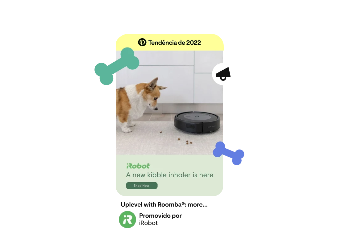 Anúncio em forma de Pin que mostra um cachorro corgi com um aspirador Roomba e ração espalhada pelo chão. O anúncio diz "chegou um novo sugador de ração" abaixo do logotipo da iRobot, e um selo "Tendência para 2022" aparece na parte superior da imagem. 