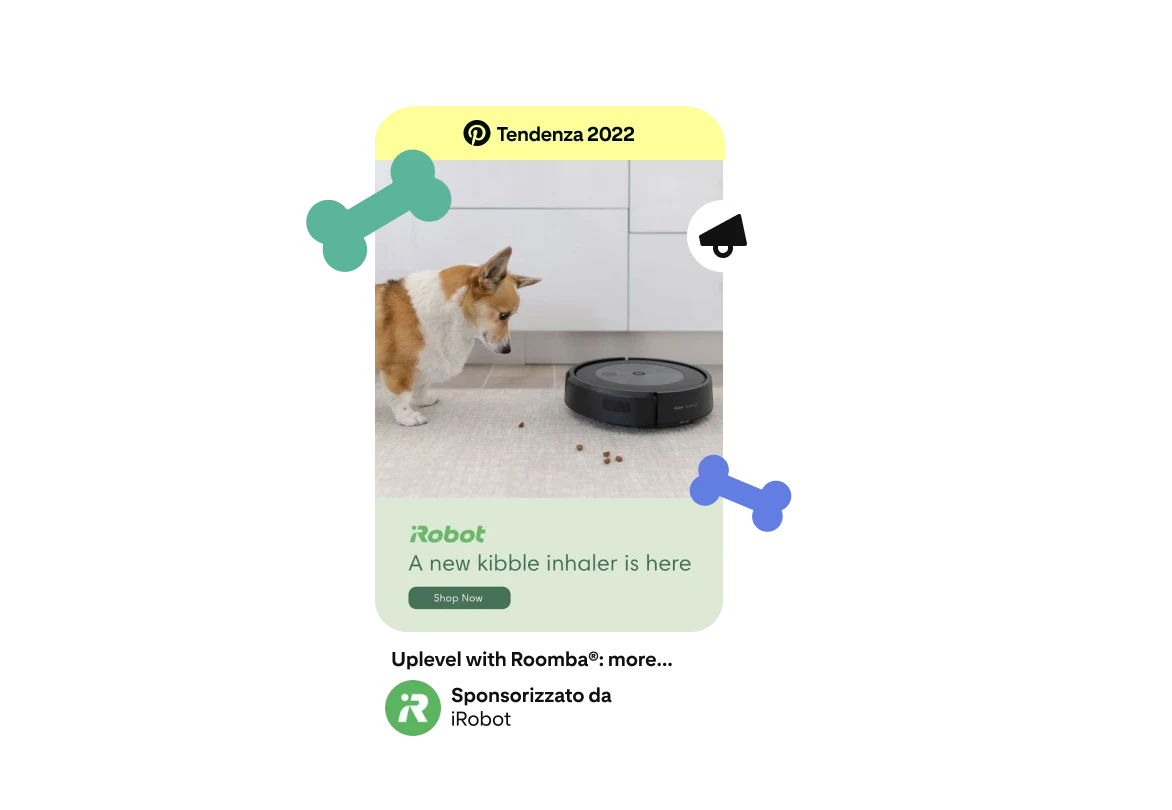 Annuncio raffigurante un cane Corgi con un'aspirapolvere Roomba e crocchette sparse sul pavimento. Sotto il logo di iRobot c'è la scritta "È arrivato il nuovo aspira crocchette". Nella parte superiore del Pin è presente il badge "Tendenza 2022". 