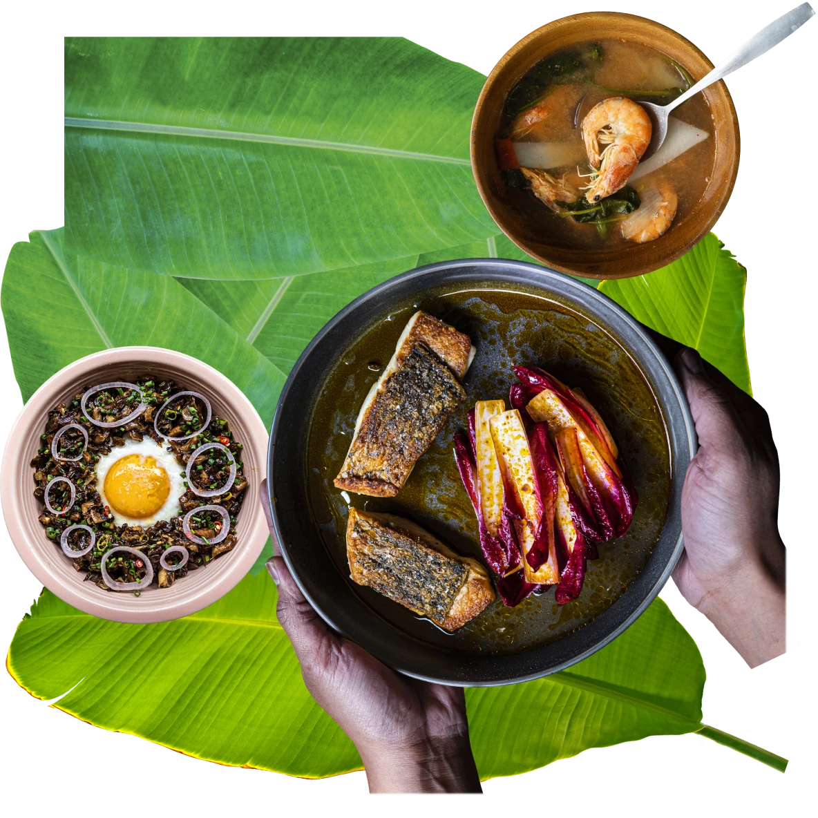 Collage of aerial views of Filipino dishes on a leafy backdrop. On the right, fish and vegetables on a dark blue plate. At top, brown bowl with shrimp soup. On the left, pink bowl with fried egg and onion.