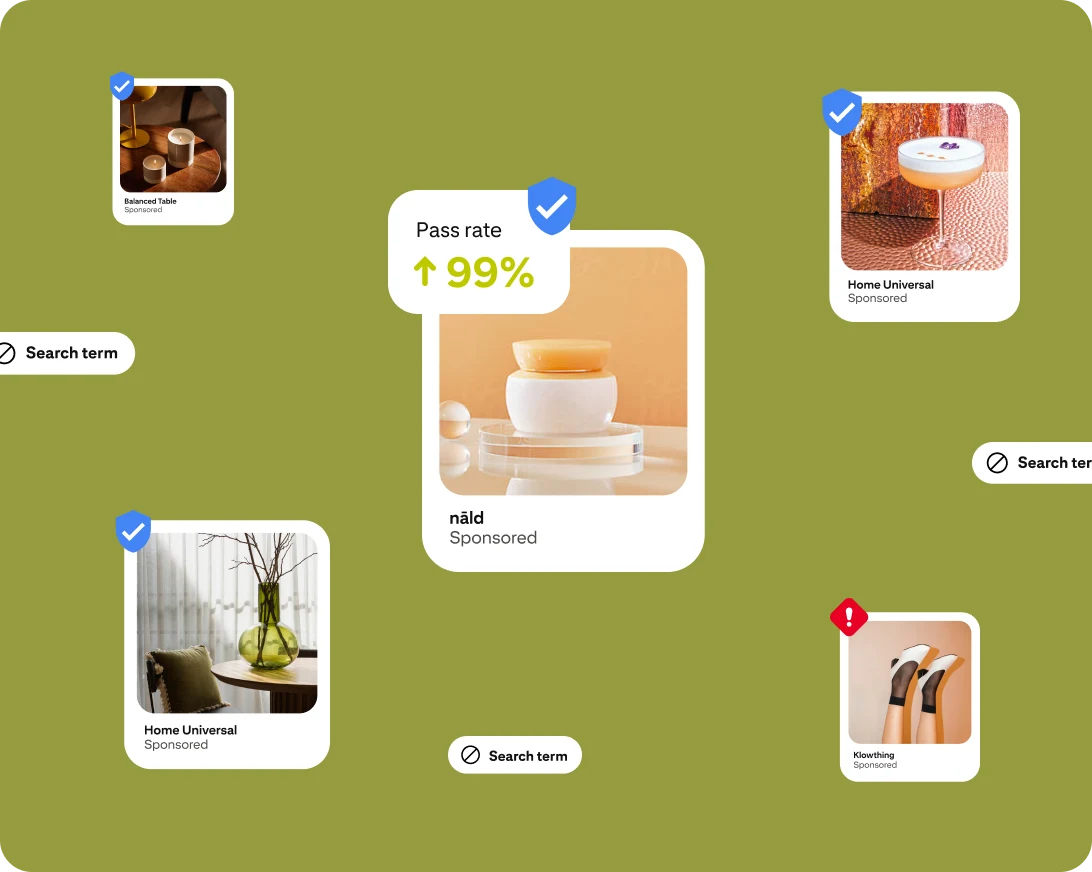 Fictitious ad images show a wooden table; a cocktail; a cosmetics jar; a vase of sticks; and white shoes. Each ad includes a badge with a blue tick or a red exclamation mark to show whether it passes audience suitability measures on Pinterest.