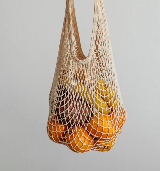 A mesh bag of oranges