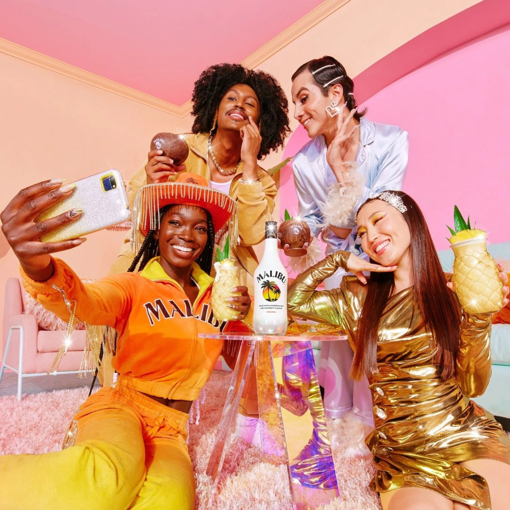 Group of diverse friends in colorful clothing and room, taking selfie around Malibu drink