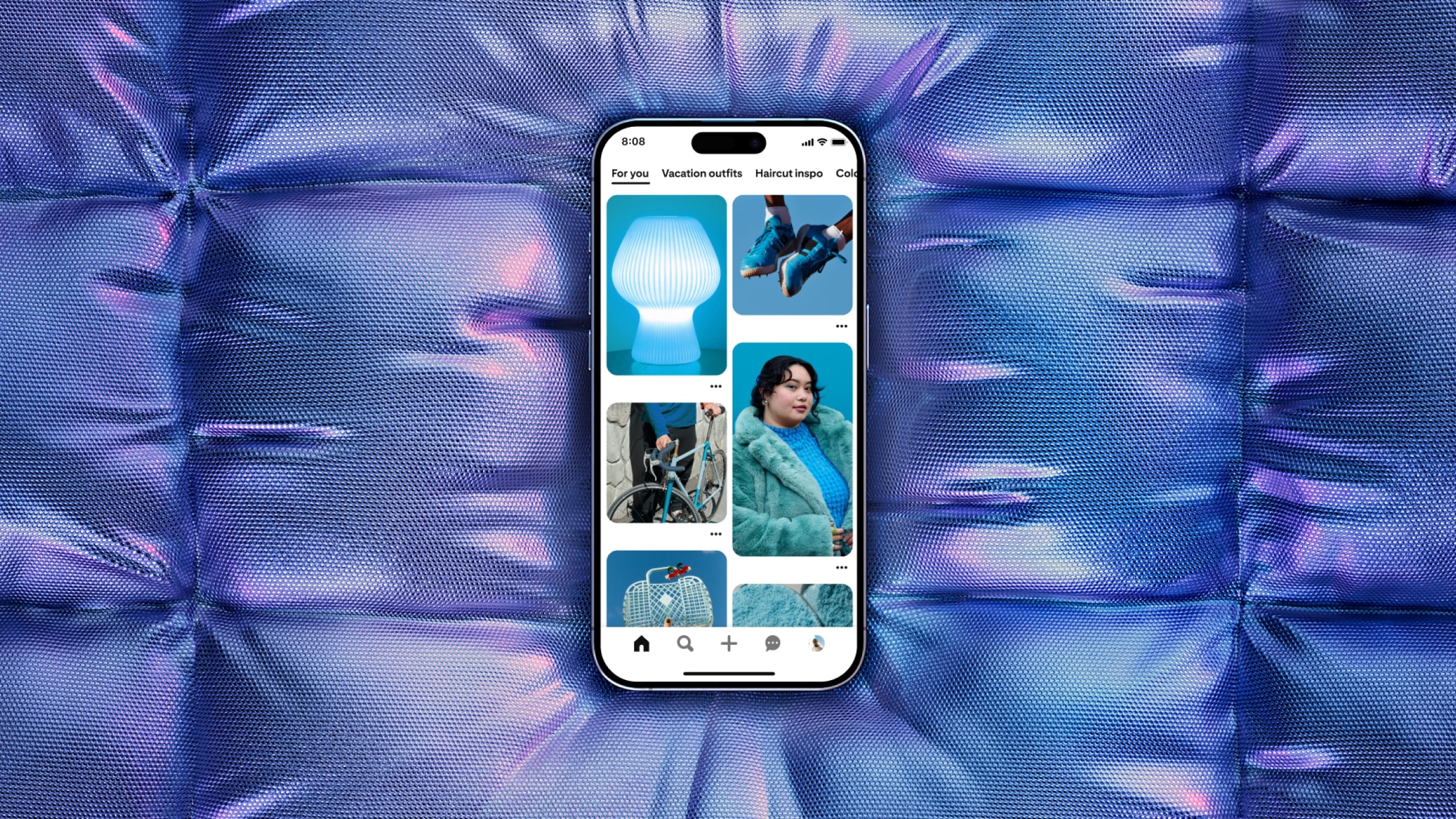 A smartphone displaying various images on its screen is centered on a background of iridescent, geometric pillow-like panels. The screen shows a light bulb, a bicycle, a purse, a pair of shoes, and a woman wearing a coat.