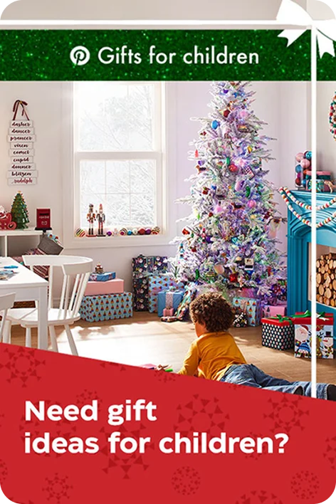 A child in a room with Christmas decorations
