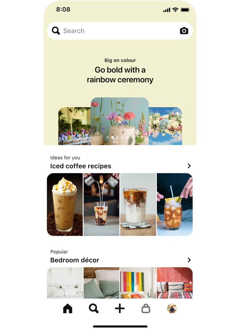 Image of a mobile app search tab with a top-aligned search bar showing three stacked nail Idea Pins titled ‘Pearlescent nails: Shimmer like glitter on the soft side of glam’. Below, a section titled ‘Ideas for you: Iced Coffee Recipes’ with four pins and another section titled ‘Popular: Bedroom décor’, also with four pins.