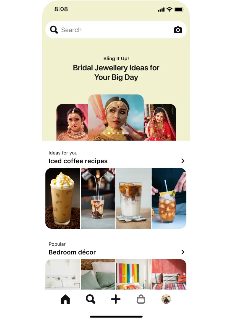 Image of a mobile app search tab with a top-aligned search bar showing three stacked nail Idea Pins titled ‘Pearlescent nails: Shimmer like glitter on the soft side of glam’. Below, a section titled ‘Ideas for you: Iced Coffee Recipes’ with four pins and another section titled ‘Popular: Bedroom décor’, also with four pins.