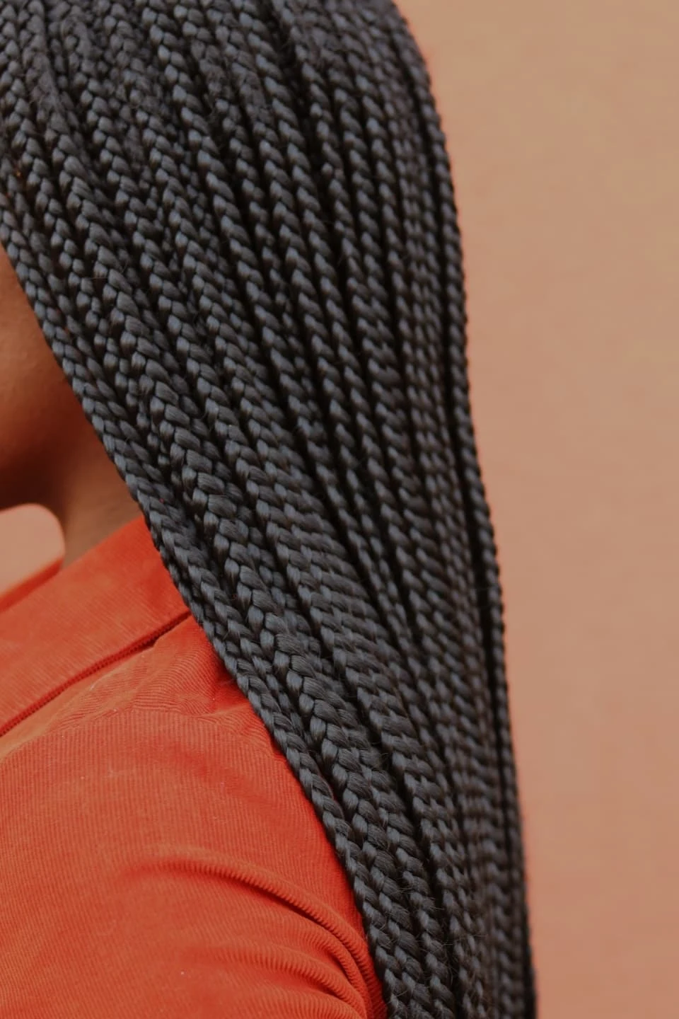 Profile of a woman with long protective braids