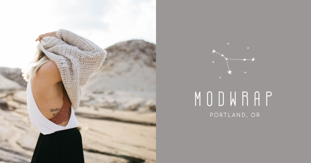 girl putting on sweater with logo