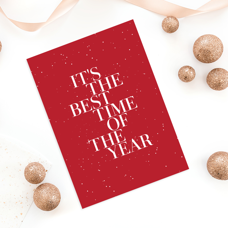 Holiday business card design with red background, snowflake texture, and text "It's the best time of the year."
