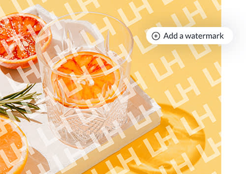 Watermarked image of glass on cutting board with sliced oranges and rosemary, along with PicMonkey's "Add a watermark" icon.