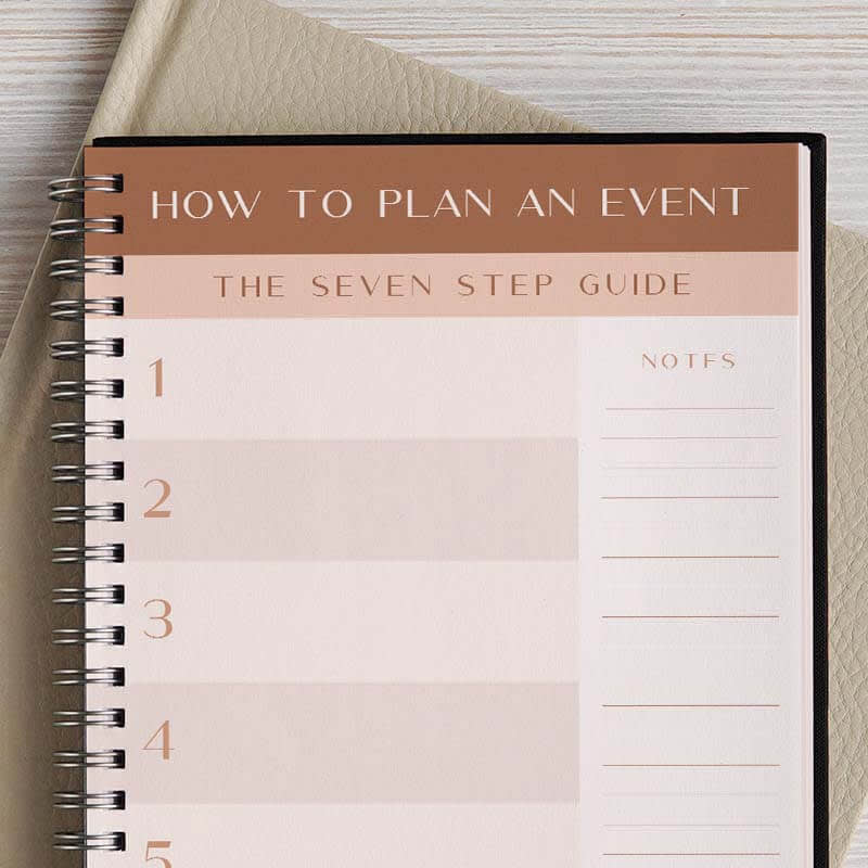 An open planner page with a light brown banner that reads "How To Plan an Event" and a light pink banner underneath that reads "The Seven Step Guide." Alternating shades of pink going down with numbers and a section for notes on the right hand side.