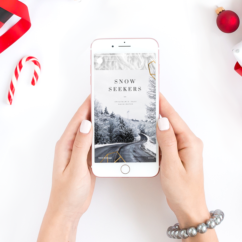 Flay lay image of hands holding iPhone with holiday-themed design template on display.