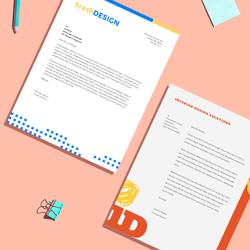 Letterhead designs ideas against a salmon colored background. 
