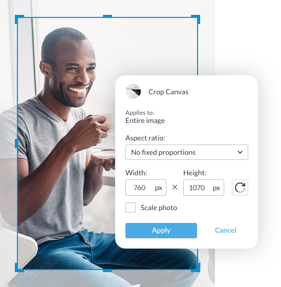 Grey background photo of a man drinking coffee in a grey v-neck t-shirt and blue jeans. Crop outline in light blue showing dimensions of PicMonkey's Crop Canvas.