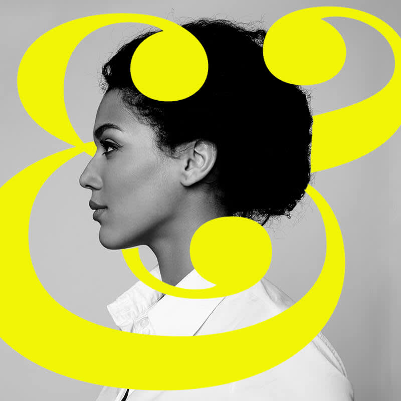 Black and white side profile of woman with yellow ampersand layered for a 3D effect.