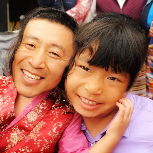 Face swap photo example with parent and child. One wearing red and gold shirt, another in purple button up.