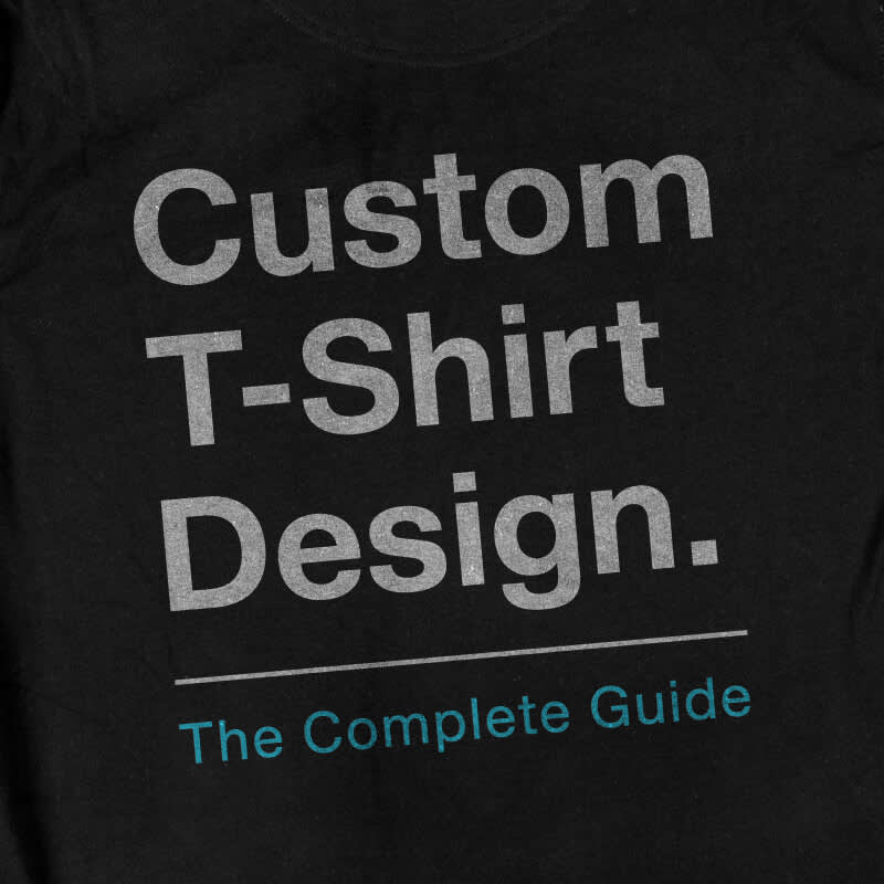 Black t-shirt background with white and blue text: "Custom T-shirt Design. The Complete Guide."