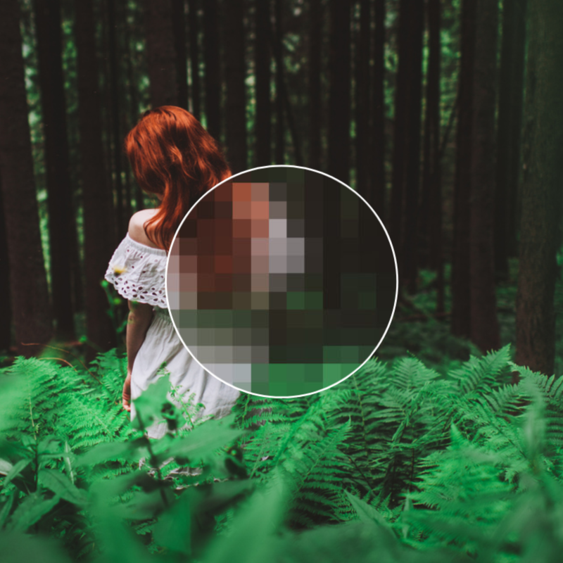 Photo of red-headed woman in white dress walking through woods among bright green leaves in partial high resolution. Focal point shows low res and background of nature trees is hi res.