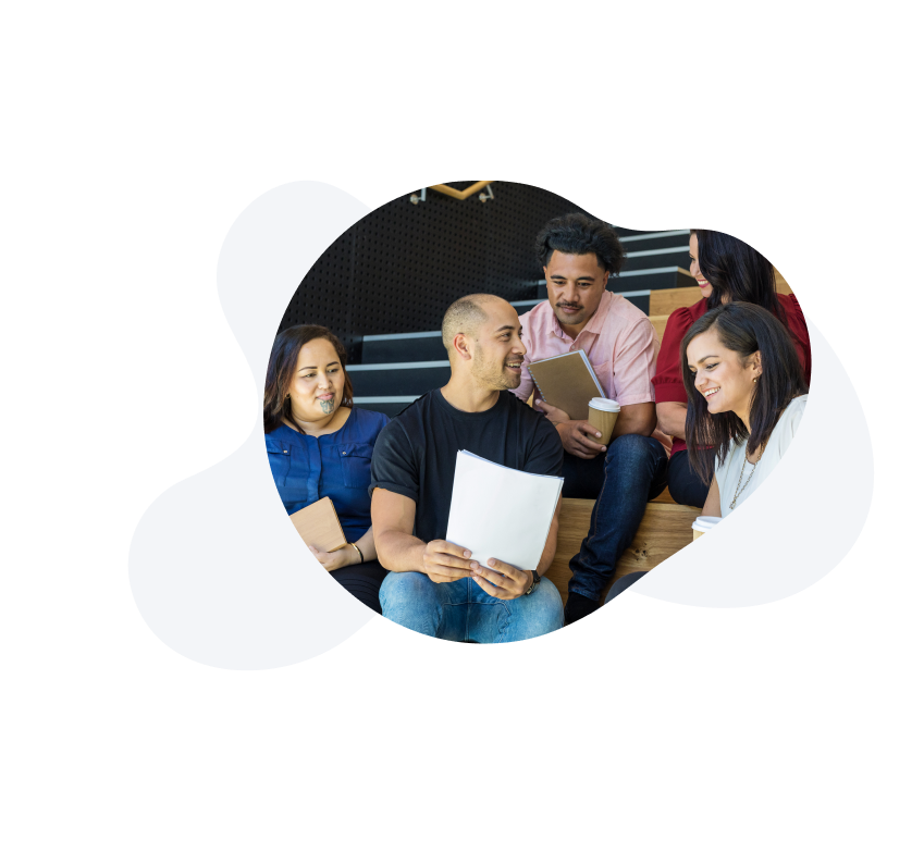 Image of a group of people looking at a sheet of paper and collaborating. 