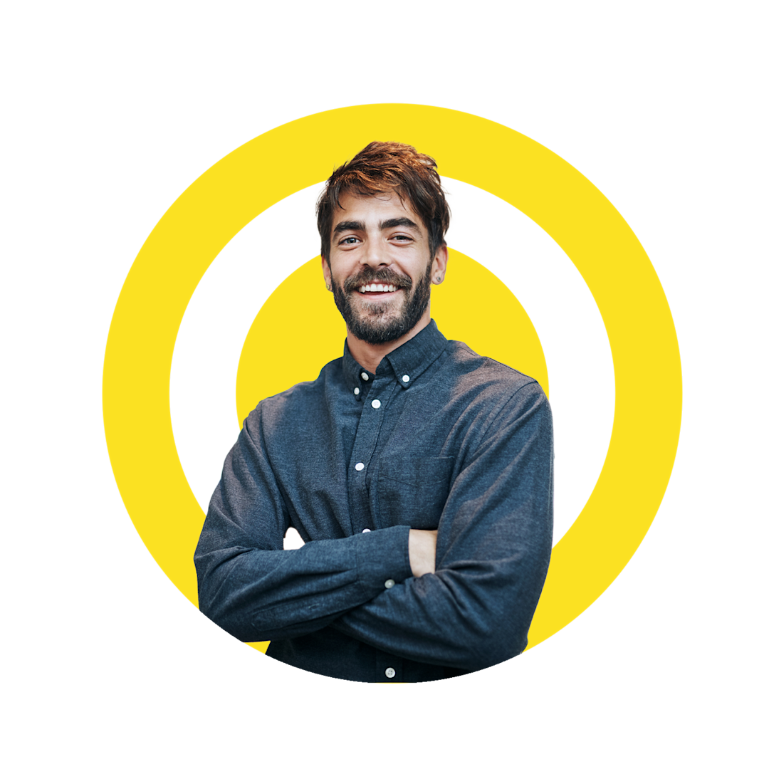A male in a navy blue dress shirt smiling at the camera, with the Yellow logo in the backdrop. 