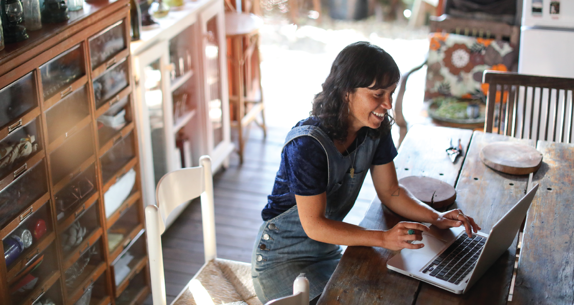Image of woman working from home, looking at the screen.