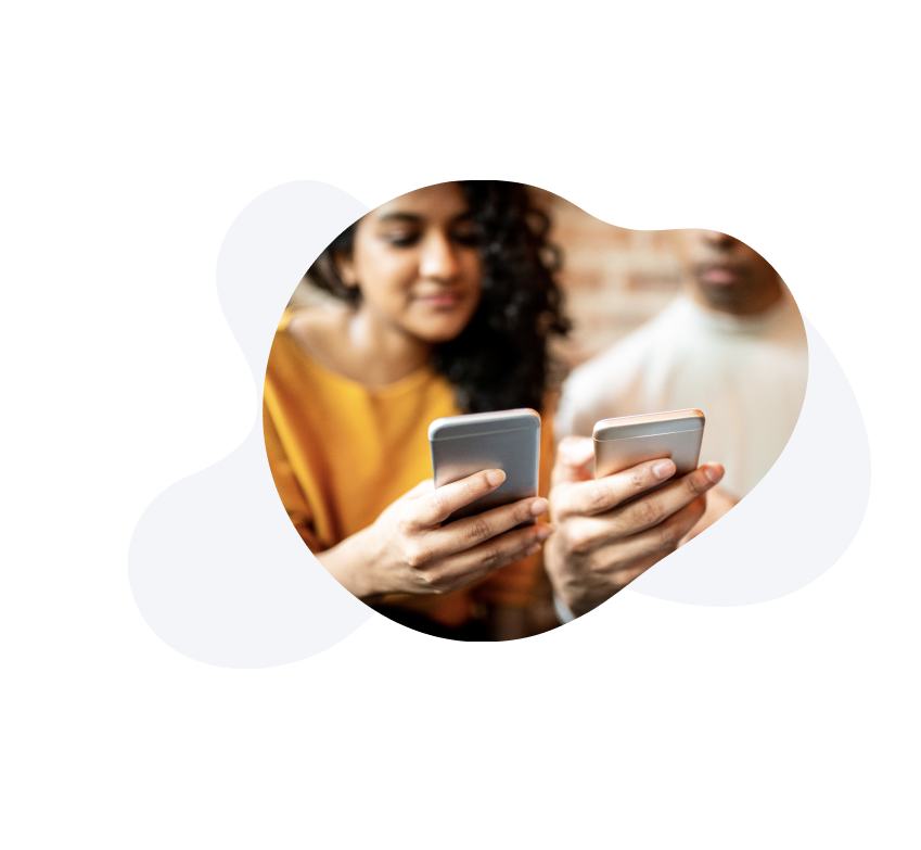 Two people holding their smartphones next to each other. 