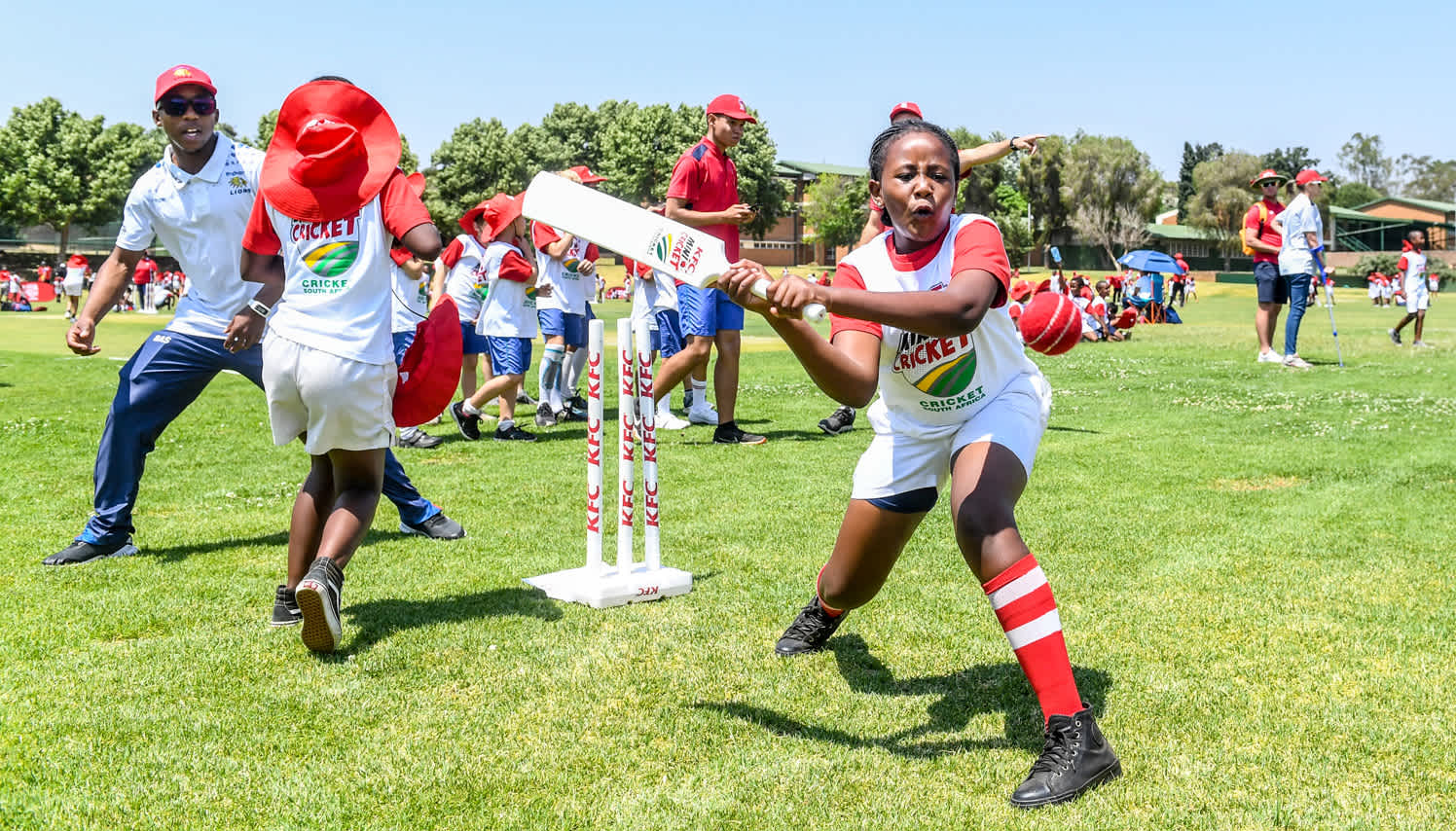 Kagiso Rapulana of the Lions working with children from Qhoweng Primary School during the KFC Mini-Cricket Provincial Festival at Queens High School