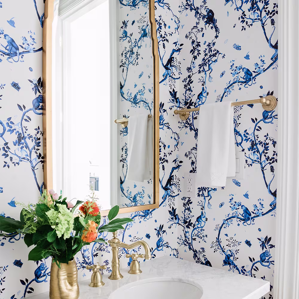 Bathroom with blue and white wallpaper.