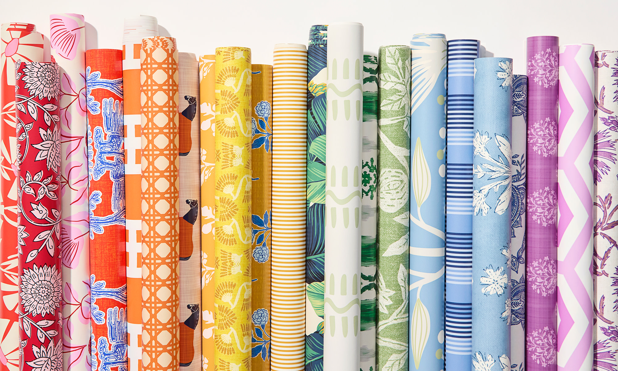 Rolls of rainbow colored wallpaper.