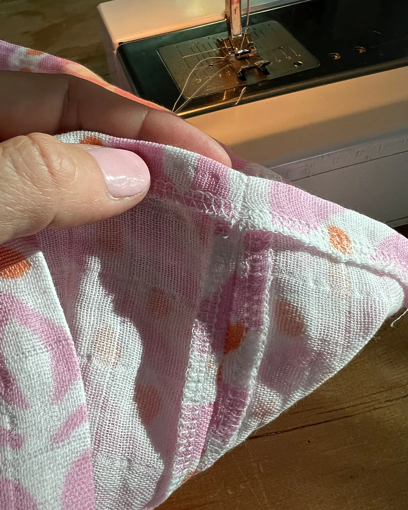 A close up of a pressed and finished caftan seam and hem.