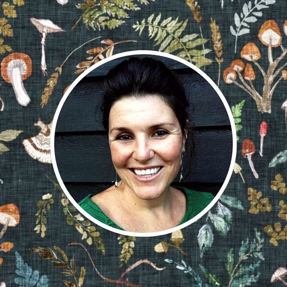 Headshot of Nouveau Bohemian behind her designed prints.