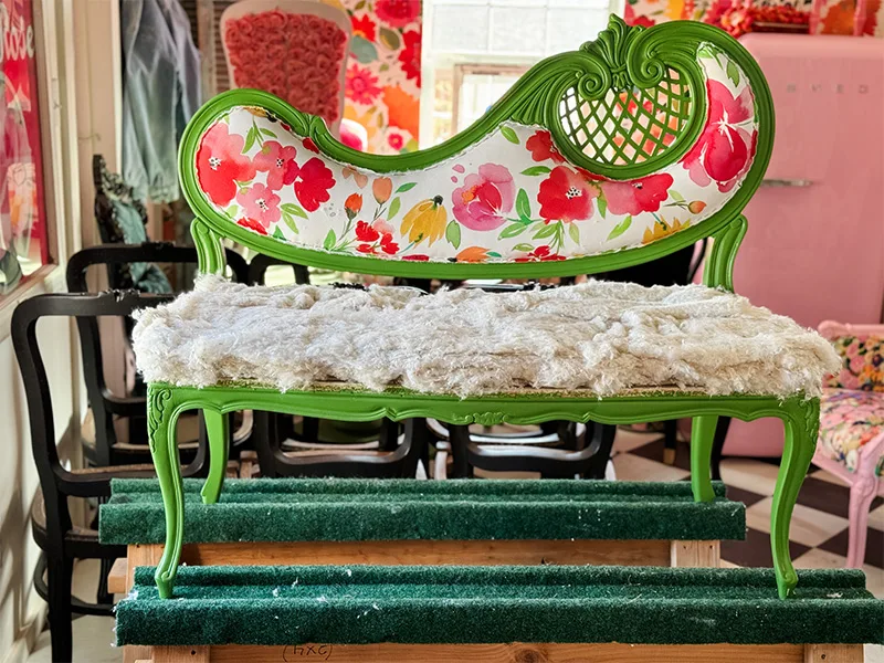 A thick layer of cotton rests on the settee chair's seating area.