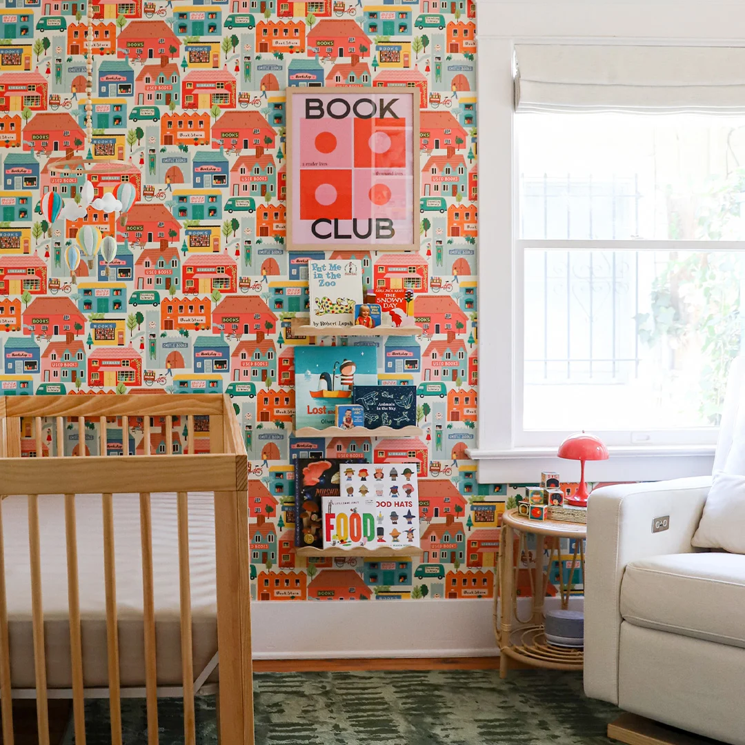 Nursery with book themed wallpaper