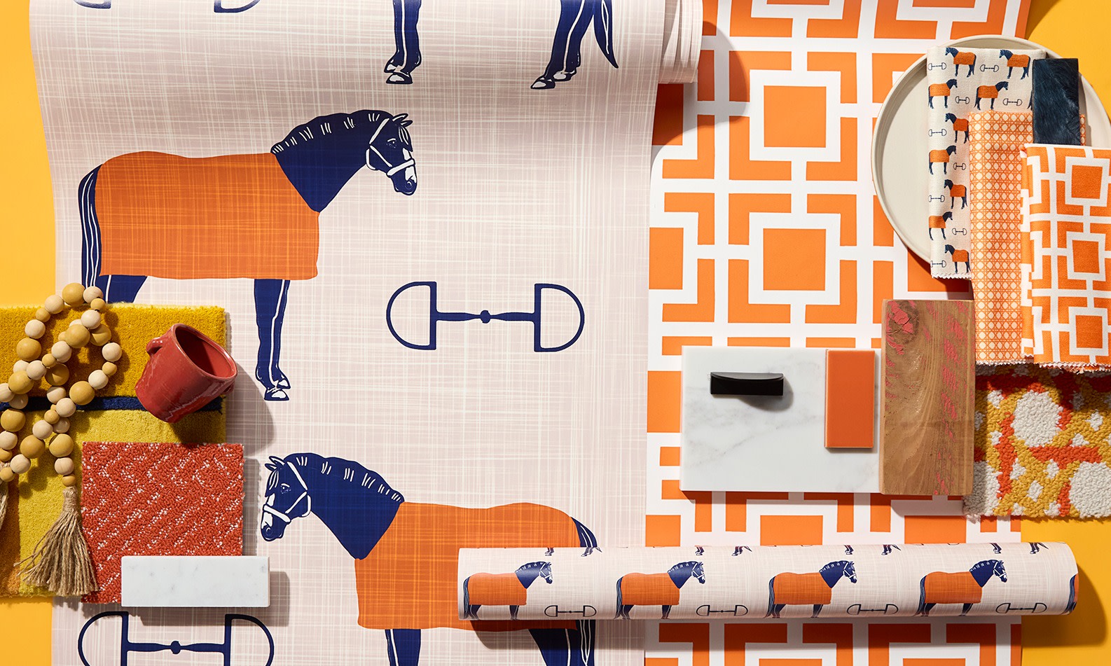 Rolls of orange wallpaper on an orange background.