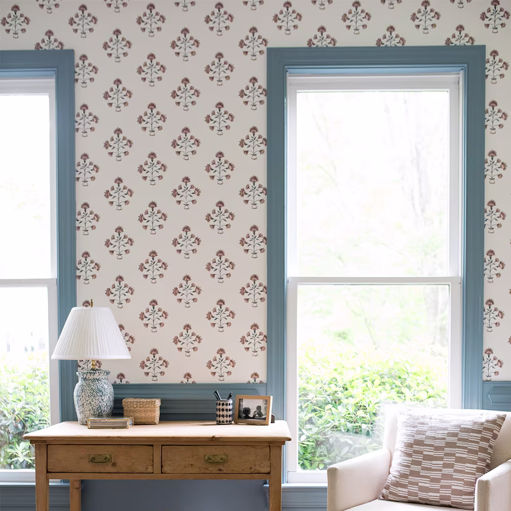 Living area with blue and rust block print style wallpaper.