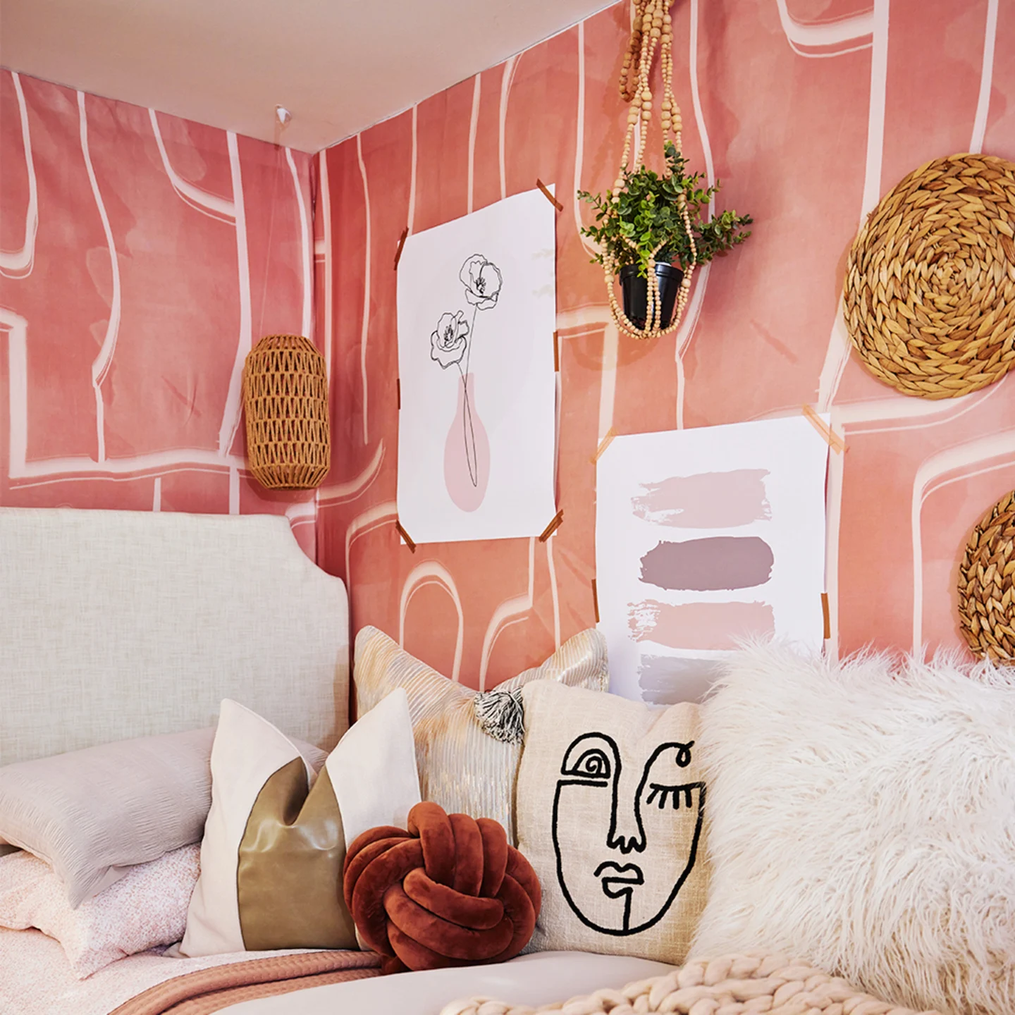 Dorm room with pink peel and stick wallpaper.