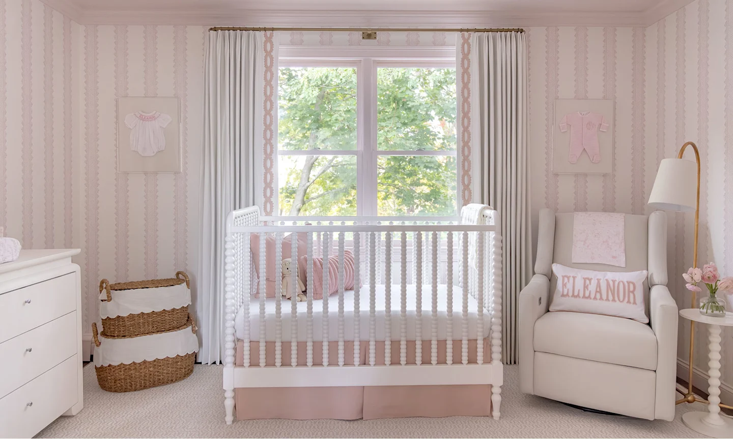 Nursery with pink stripe wallpaper.