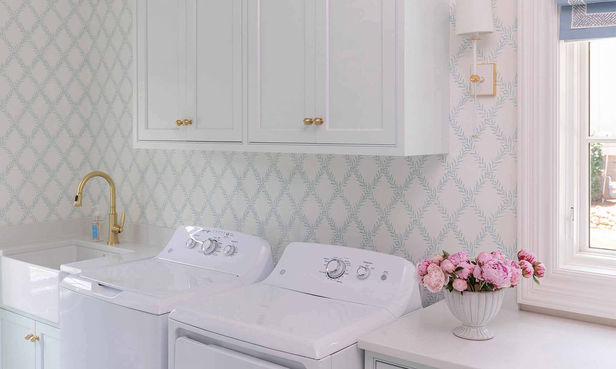 Laundry room with trellis wallpaper.