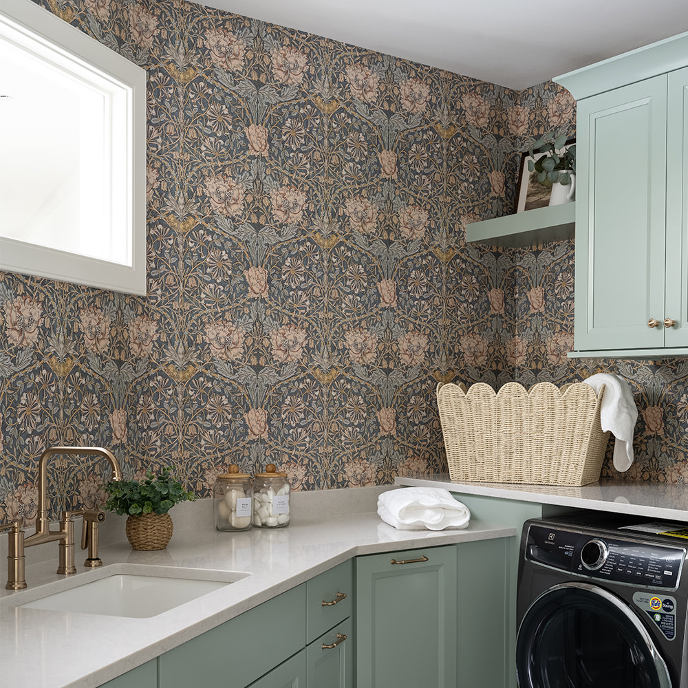 William Morris inspired wallpaper in a laundry room.