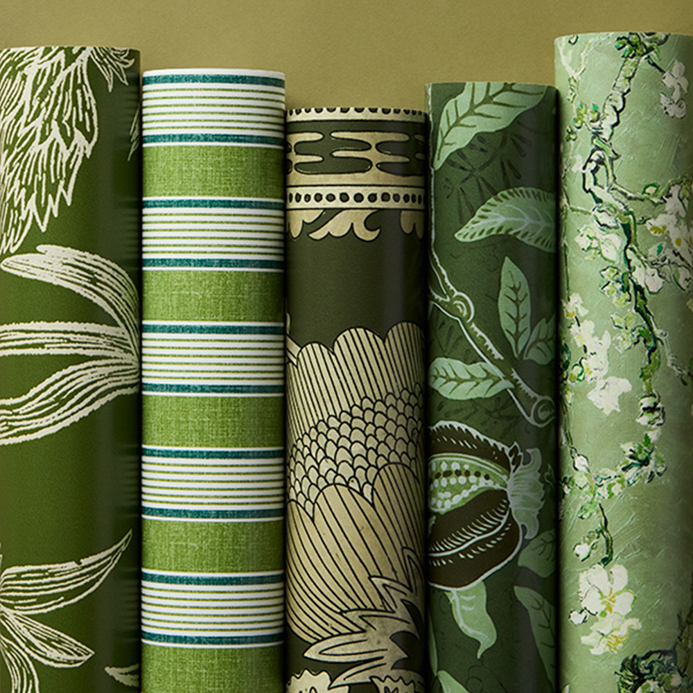 Rolls of biophillic green wallpaper.