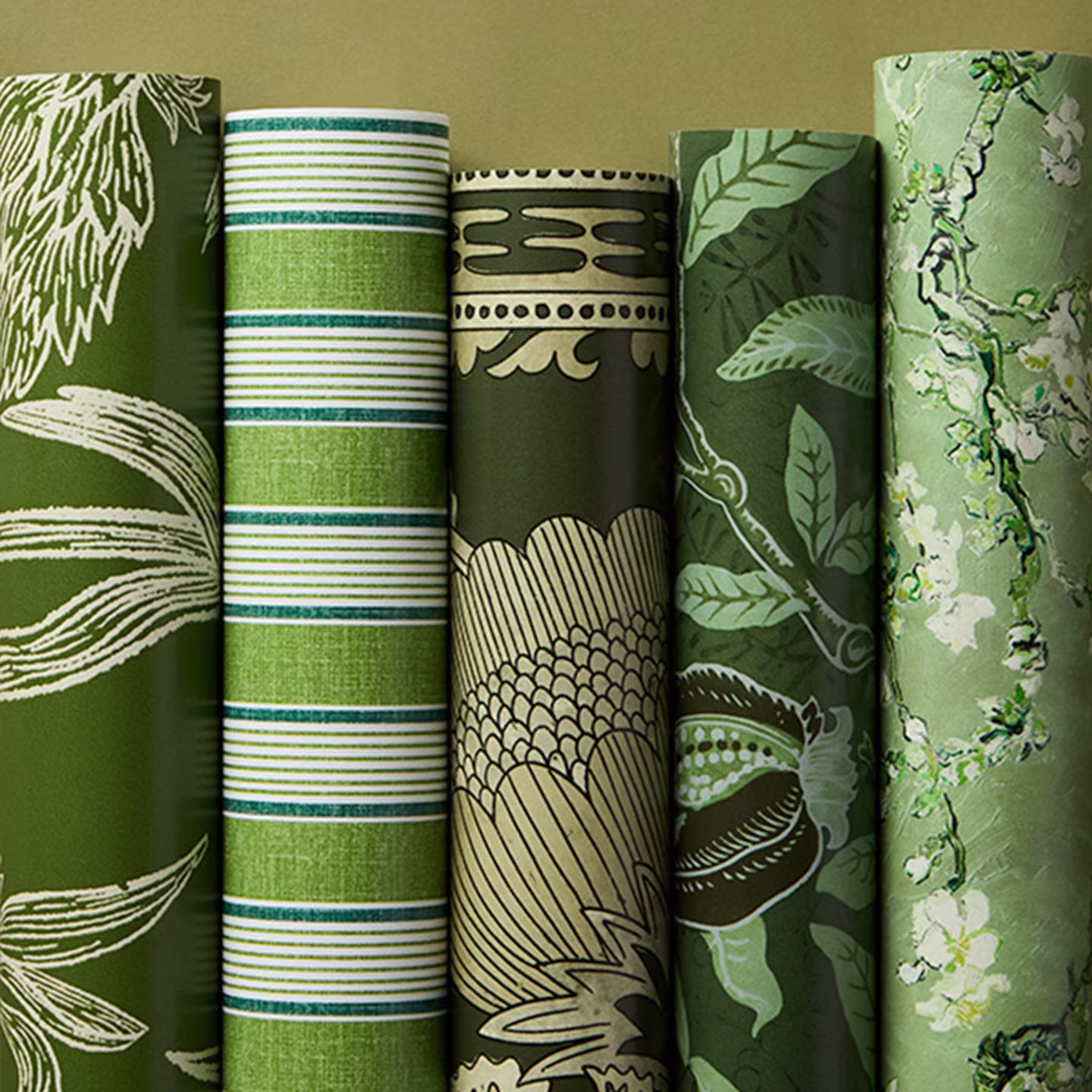 Rolls of biophillic green wallpaper.