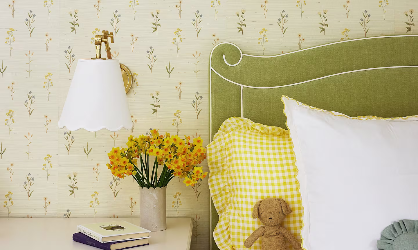 Green heaboard bed with white linens and night table.