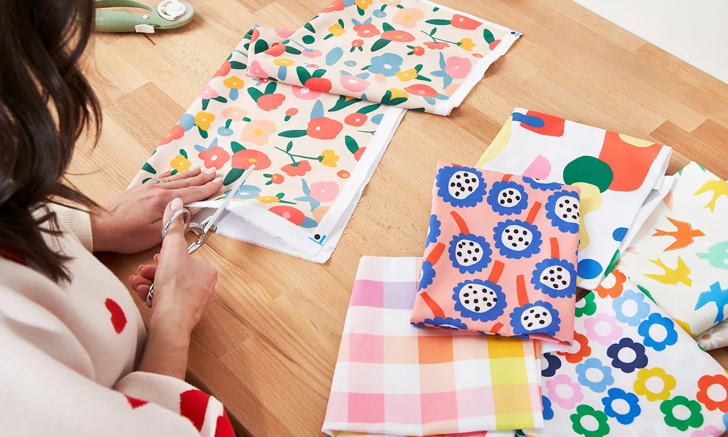 Person cutting Spoonflower fabric with shears.