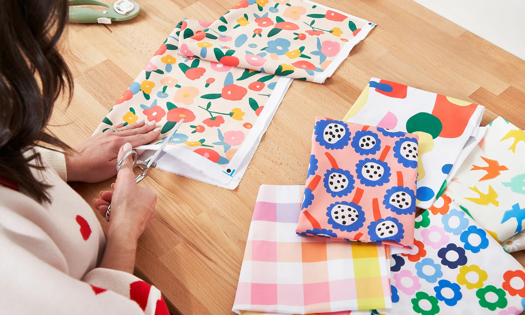 Person cutting Spoonflower fabric with shears.